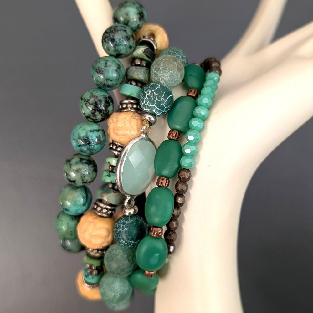 Bundle of green beaded stretch bracelets